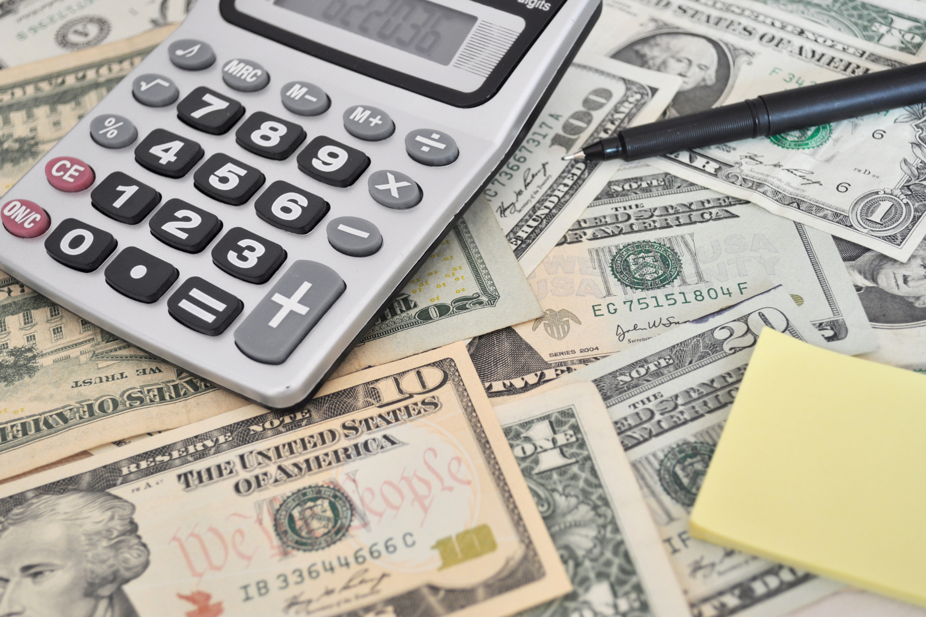 money cash scattered calculator budgeting